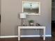 Console table in entry with lamp, mirror, and decorations at 5045 Musselshell Dr, New Port Richey, FL 34655