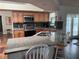 Open kitchen featuring granite countertops, stainless steel appliances, and a breakfast bar with seating at 5045 Musselshell Dr, New Port Richey, FL 34655