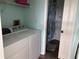 Functional laundry area with washer, dryer, and convenient access to a bathroom at 5045 Musselshell Dr, New Port Richey, FL 34655
