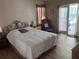 Spacious main bedroom with hardwood floors, a sliding glass door to the pool, and a sitting area at 5045 Musselshell Dr, New Port Richey, FL 34655