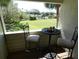 Balcony with outdoor seating and a view of the green area at 545 Walden Ct, Dunedin, FL 34698