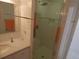 Bathroom with a stand-up shower, white marble vanity, and large mirror at 545 Walden Ct, Dunedin, FL 34698