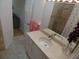 Bright bathroom featuring a vanity with a marble countertop, sink, and modern fixtures at 545 Walden Ct, Dunedin, FL 34698