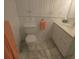 Clean bathroom with marble floors, white cabinets, and a toilet at 545 Walden Ct, Dunedin, FL 34698