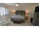 Bright bedroom with neutral tones, a ceiling fan, and a large window for plenty of natural light at 545 Walden Ct, Dunedin, FL 34698
