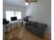 Versatile bedroom with hardwood floors, a neutral color scheme, a desk area, and a comfortable sofa at 545 Walden Ct, Dunedin, FL 34698