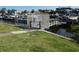 A gate to a boat dock and lift with lush green surroundings, enhancing waterfront appeal at 545 Walden Ct, Dunedin, FL 34698