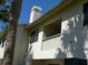 Exterior view of the building showing its architectural details and balcony overlooking the grounds at 545 Walden Ct, Dunedin, FL 34698