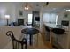 Stylish living room with dining and kitchen bar featuring updated fixtures at 545 Walden Ct, Dunedin, FL 34698