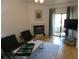 Inviting living room with a fireplace, comfortable seating, and a sliding glass door at 545 Walden Ct, Dunedin, FL 34698