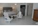 A spacious bedroom with a queen-sized bed, tile floor, a TV and casual seating at 545 Walden Ct, Dunedin, FL 34698