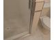 Walk-in shower with glass door and tiled floor at 545 Walden Ct, Dunedin, FL 34698
