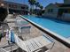 Outdoor swimming pool featuring lounge chairs and table creating an inviting area for socializing and sunbathing at 545 Walden Ct, Dunedin, FL 34698