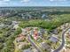 Aerial view of the property in a suburban setting, surrounded by greenery, ponds, and residential streets at 6109 Japonica Ct, New Port Richey, FL 34655