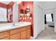 Well-lit bathroom with vanity and dual mirrors, connecting to the main bedroom at 6109 Japonica Ct, New Port Richey, FL 34655