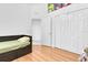Cozy bedroom with wood floors, bed with drawers, triple closet and doorway visible at 6109 Japonica Ct, New Port Richey, FL 34655