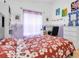 Comfortable bedroom with desk and artwork, showcasing a playful and creative design at 6109 Japonica Ct, New Port Richey, FL 34655