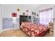 Charming bedroom with hardwood floors, vibrant floral bedding, and a cheerful ambiance at 6109 Japonica Ct, New Port Richey, FL 34655