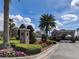 Magnolia Estates entrance with stone pillars, signage, landscaping, and gated entry at 6109 Japonica Ct, New Port Richey, FL 34655