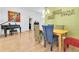 Bright dining room with eclectic chairs, a wooden table, piano and artwork nearby at 6109 Japonica Ct, New Port Richey, FL 34655