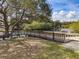 Wooden dock with a railing, offering views of the lake and surrounding greenery at 6109 Japonica Ct, New Port Richey, FL 34655