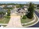 Stunning exterior view of a well-manicured home with a three-car garage and a brick-paved driveway at 6109 Japonica Ct, New Port Richey, FL 34655