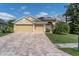 Beautiful home with a three-car garage and a brick paver driveway at 6109 Japonica Ct, New Port Richey, FL 34655