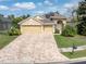 Beautiful home with a three-car garage and a brick paver driveway at 6109 Japonica Ct, New Port Richey, FL 34655