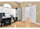 Home office featuring a full desk setup, storage cabinet, and two entryways at 6109 Japonica Ct, New Port Richey, FL 34655