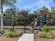 Community playground with swings, slides, climbing structures, and fencing at 6109 Japonica Ct, New Port Richey, FL 34655
