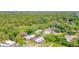 This aerial shows the home in a neighborhood surrounded by lush greenery at 6507 Ginny Dr, Port Richey, FL 34668