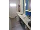 Functional bathroom featuring a vanity with sink, toilet, and storage, designed for convenience and practicality at 6507 Ginny Dr, Port Richey, FL 34668