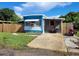 Charming single-story home with blue and white trim, a small front yard, and a motorcycle parked outside at 6507 Ginny Dr, Port Richey, FL 34668