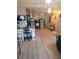 Open-concept living space featuring laminate floors, kitchen, and cozy desk area for versatile living at 6507 Ginny Dr, Port Richey, FL 34668