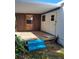 Covered patio with blue stairs and door access into the home at 6507 Ginny Dr, Port Richey, FL 34668