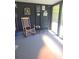 Relaxing porch with rocking chair and black decor, perfect for enjoying the outdoors at 6507 Ginny Dr, Port Richey, FL 34668