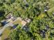 An aerial view displays the cozy homes nestled among the lush greenery of the encompassing trees at 7101 N 18Th St, Tampa, FL 33610