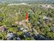 An aerial view showing a home nestled amongst mature trees, and surrounded by other residences at 7101 N 18Th St, Tampa, FL 33610