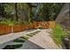 Landscaped backyard retreat with gravel, pavers, integrated lighting, and wooden fencing for privacy at 7101 N 18Th St, Tampa, FL 33610