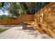 Outdoor space with a wooden privacy fence, built-in bench seating, and stone pavers with lush foliage at 7101 N 18Th St, Tampa, FL 33610