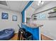 Basement bar area with a counter, stools, neon sign, and decorative shelving, ideal for entertaining at 7101 N 18Th St, Tampa, FL 33610