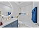 Modern bathroom features updated vanity, decorative tiling and glass enclosed shower with gold hardware at 7101 N 18Th St, Tampa, FL 33610