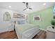 Bright bedroom features hardwood floors, a ceiling fan, and charming decor at 7101 N 18Th St, Tampa, FL 33610