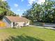 Lovely single-story home featuring a well-maintained lawn, mature trees, and beautiful landscaping at 7101 N 18Th St, Tampa, FL 33610