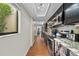 Modern kitchen with stainless steel appliances, granite countertops, and dark wood cabinets, perfect for cooking at 7101 N 18Th St, Tampa, FL 33610