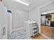 Functional laundry room featuring washer, dryer and ample storage space with convenient kitchen access at 7101 N 18Th St, Tampa, FL 33610