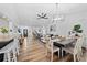 Open-concept living area with hardwood floors, modern lighting fixtures, and stylish decor creating a welcoming atmosphere at 7101 N 18Th St, Tampa, FL 33610