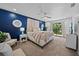 Spacious main bedroom boasts a dark blue accent wall, large bed and access to outdoor balcony at 7101 N 18Th St, Tampa, FL 33610