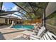 Relaxing screened pool area with brick pavers, sun loungers and basketball hoop for Gathering fun at 7101 N 18Th St, Tampa, FL 33610