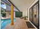 Charming outdoor living space featuring a textured patio, seating area, and serene pool views at 7101 N 18Th St, Tampa, FL 33610